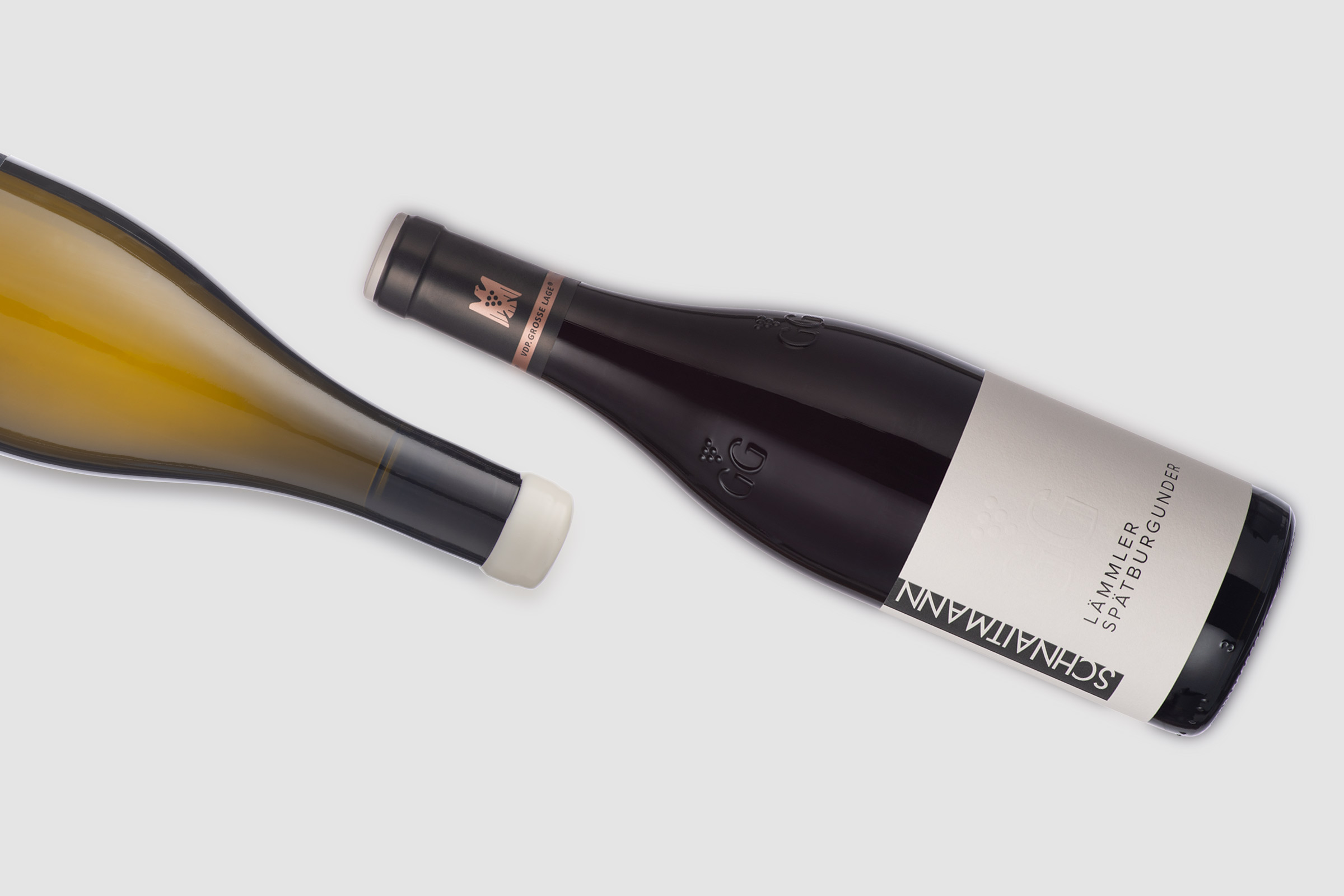 Zwei Flaschen von Weingut Schnaitmann die quer im Bild liegen.